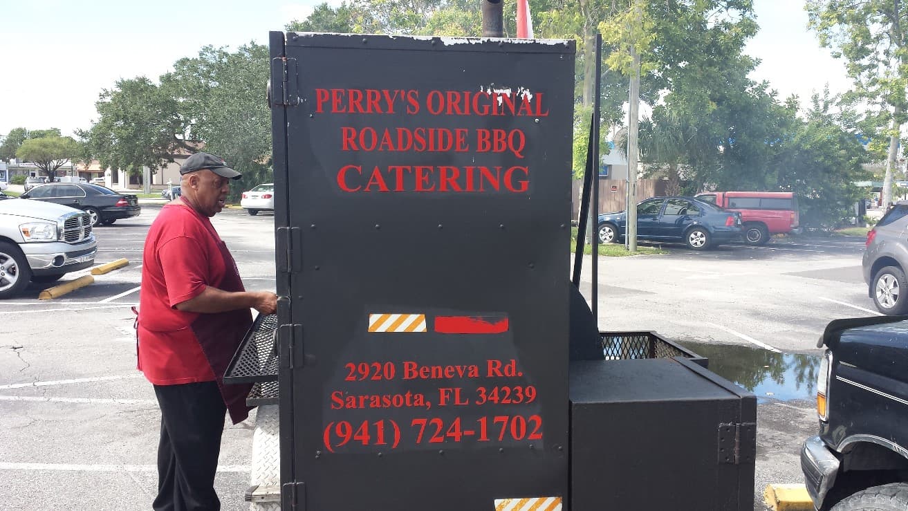Perry's smoker rig and pitmaster at work